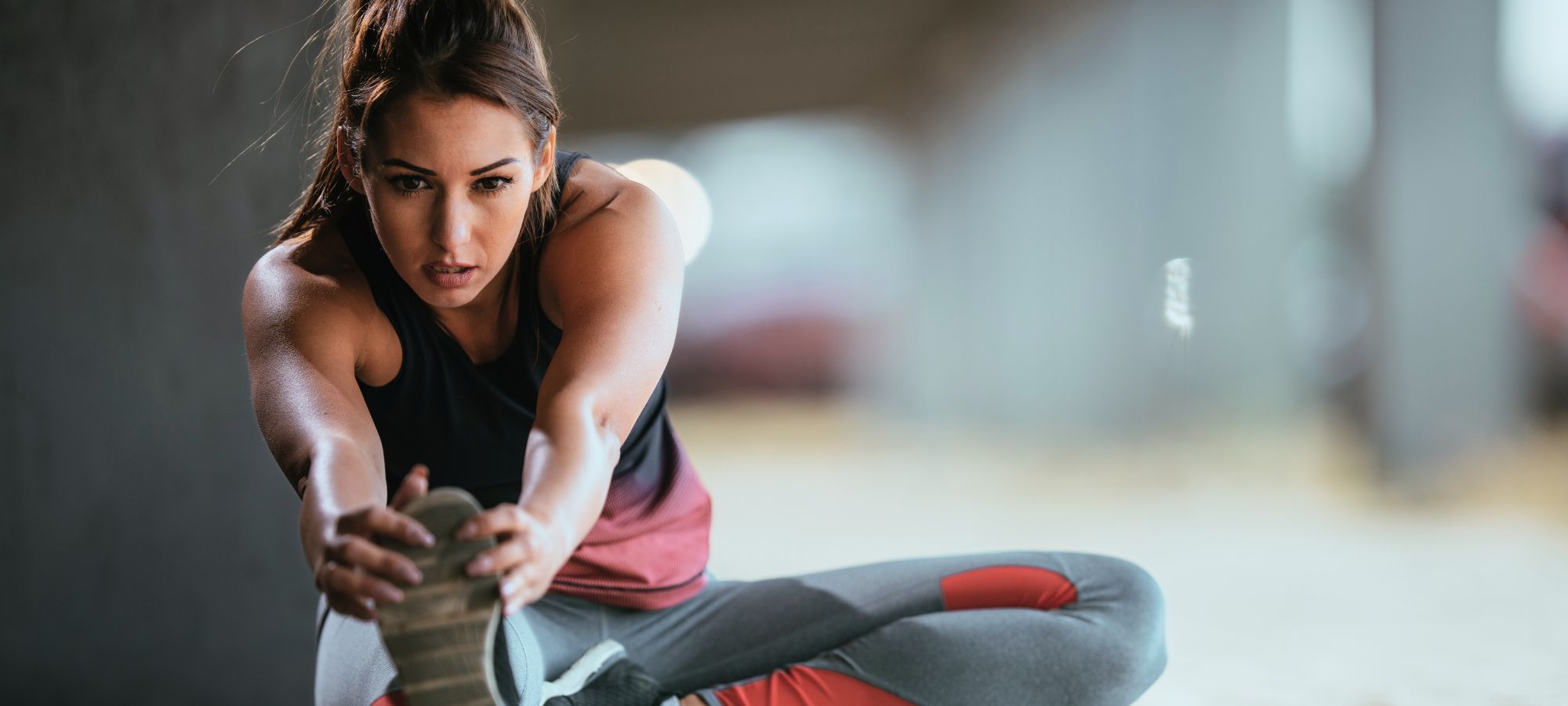 Focused athlete stretching before a workout, representing the full range of E3Live products that support physical performance, energy, and overall wellness.